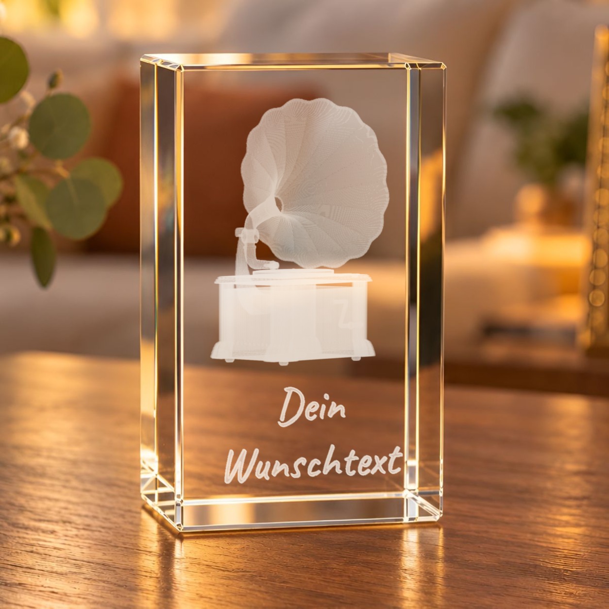 Glaskristall Grammofon mit Wunschtext, 3D-Innengravur, steht im Wohnraum auf einem Holztisch im warmen Licht