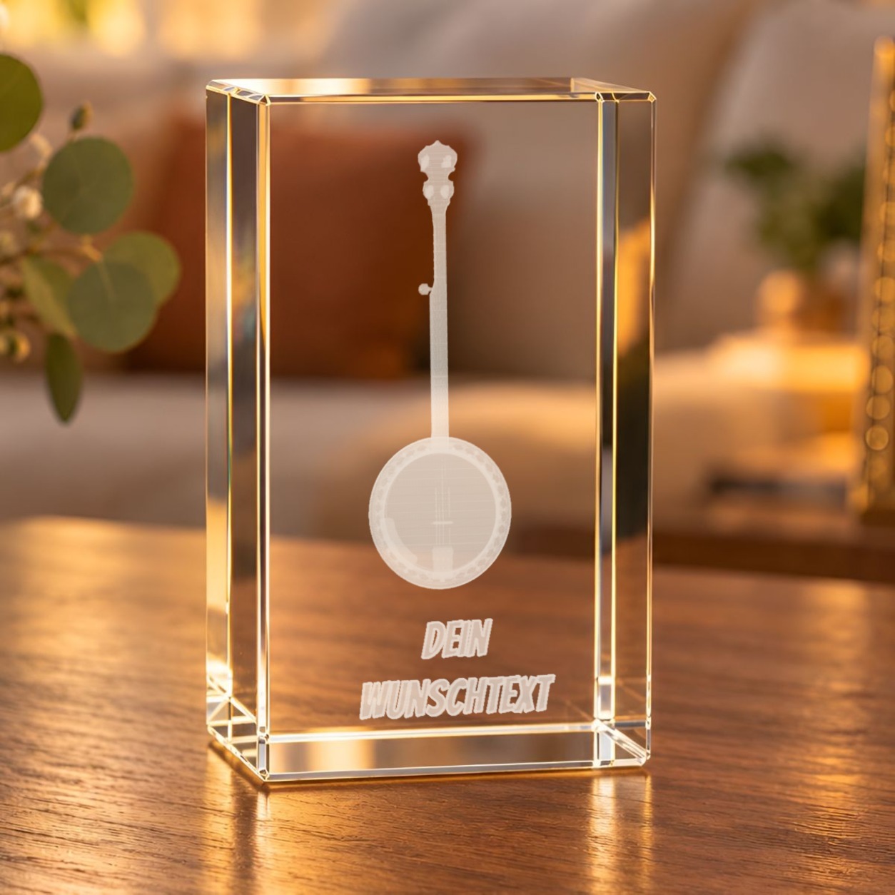 3D-Glaskristall Banjo mit Wunschtext auf einem Holztisch im Wohnzimmer bei warmem Licht