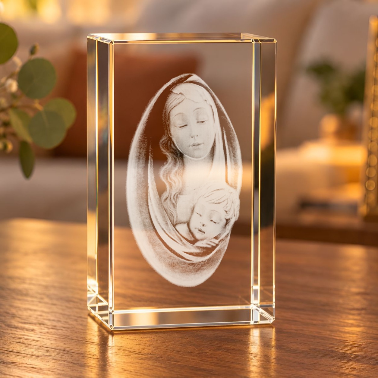 Glaskristall Maria mit Jesuskind mit 3D-Laserinnengravur auf einem Holztisch im Wohnraum